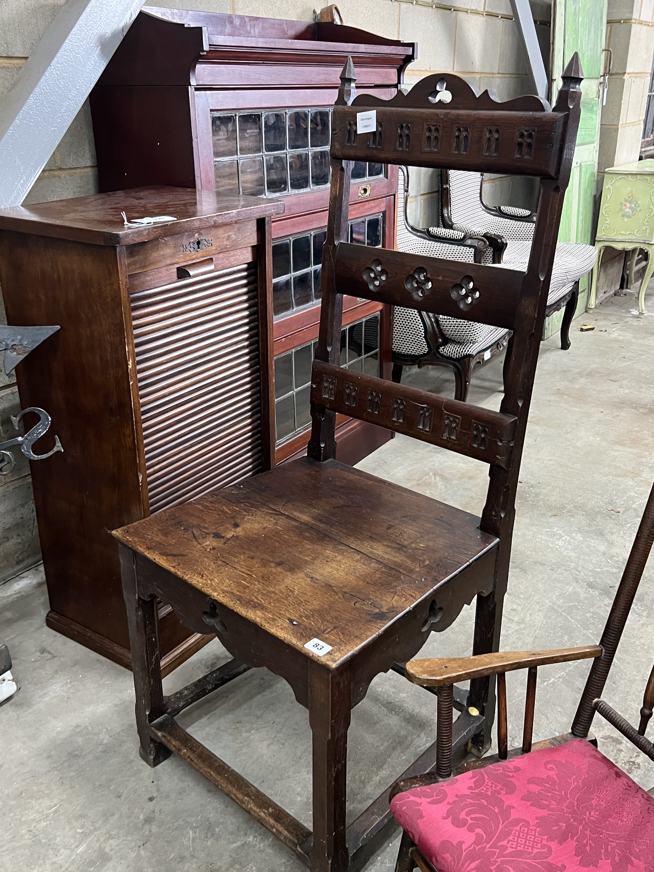 A Victorian carved oak high-back chair, width 49cm, height 118cm together with an early 20th century child's rocking chair